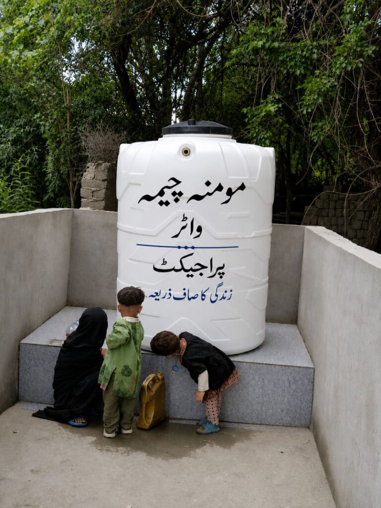 Children collecting water at a Momina Cheema Water Project tank